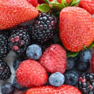 A vibrant close-up of fresh strawberries, raspberries, blackberries, and blueberries.